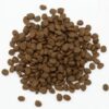 A pile of brown dog food on top of a white surface.